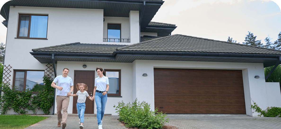 Family walking outside modern suburban house.