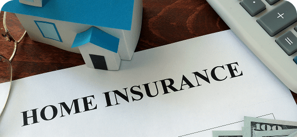 Home insurance document, model house, calculator.