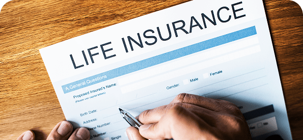 Hand filling out life insurance form.