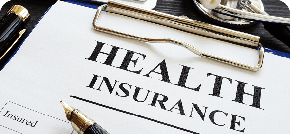 Health insurance form with pen and stethoscope.
